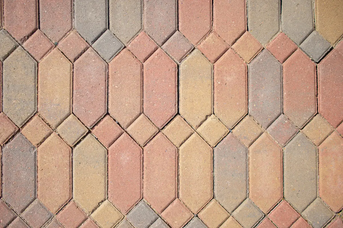 Jardinier utilisant une débroussailleuse 4 en 1 avec harnais pour entretenir une bordure de jardin